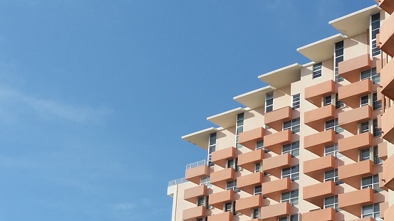 This is a photograph of a part of a large Art Deco building balconies with blue sky in Miami Beach, Florida USA.