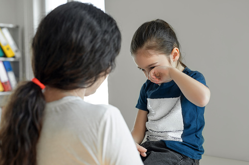 Mother is feeling sorry for a crying child