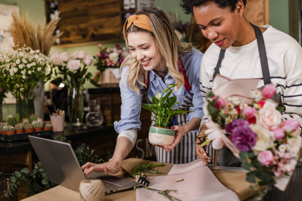 istock Two women are using a laptop in their flower workshop 1482822147