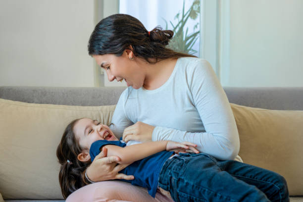 istock Happy smiling laughing mother playing with daughter 1482826050