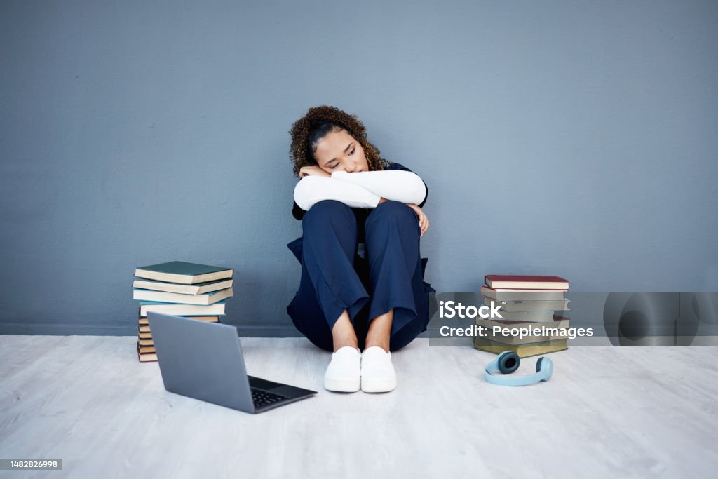 Nurse, stress and medical student depression on laptop, research books or hospital fatigue in learning burnout. Tired, sad and healthcare woman by technology in medicine internship anxiety on mock up Medical Student Stock Photo