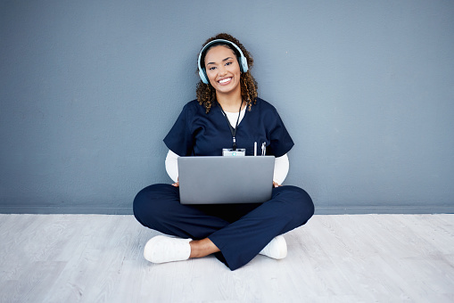 Portrait, laptop or headphones of hospital music, podcast or radio in woman study research or mock up nurse learning. Smile, happy or medical student on technology and listening to healthcare audio