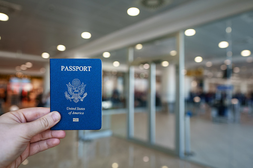 Man hodling passport of United States of America.