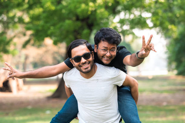 istock Cheerful young friends having fun at park 1482828163