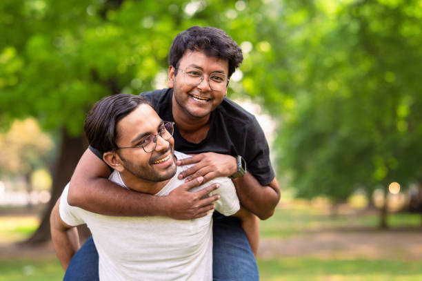 istock Cheerful young friends having fun at park 1482828336