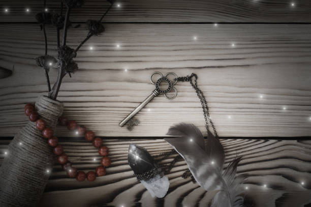 istock Magic tools on wooden background, a key, black quartz, bottle, feather and jasper bracelet. 1482830223