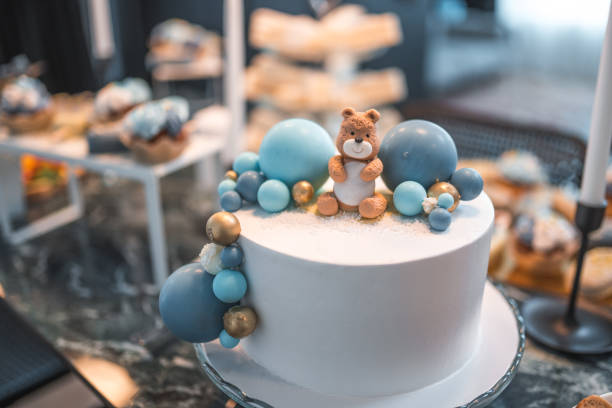 A wide selection of delicious desserts and a special cake in the focus of the photo. Baby shower celebration.