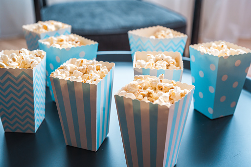 Boxes of popcorn for the guests at the baby shower party.