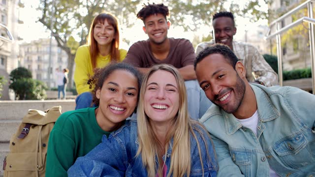 Portrait group of happy young people smiling at camera outdoor