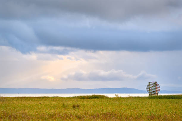 A radar reflector and storm clouds off the West Dyke Trail in Richmond, British Columbia, Canada.