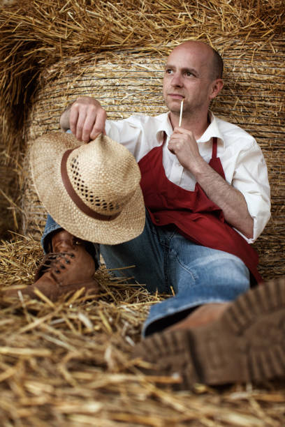 istock tired farmer worker is resting near straw bales 1482832956