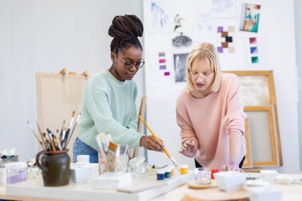 istock Young female artists are in their painting studio 1482833486