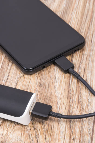 istock External powerbank using to charge empty battery of black smartphone 1482835346