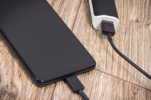 istock External powerbank using to charge empty battery of black smartphone 1482835357