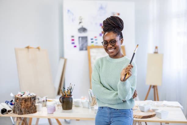 istock Young female artist is in her painting studio 1482835538