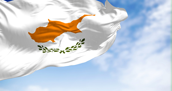 Cyprus national flag waving in the wind on a clear day. White with a copper-orange island silhouette and two green olive branches below it. 3d illustration render. Fluttering textile