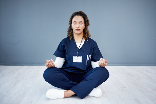 Nurse, calm or sitting meditation on hospital mockup, clinic mock up or wall for mental health, peace or chakra wellness. Doctor, healthcare or meditating woman for zen mindset, relax energy or yoga