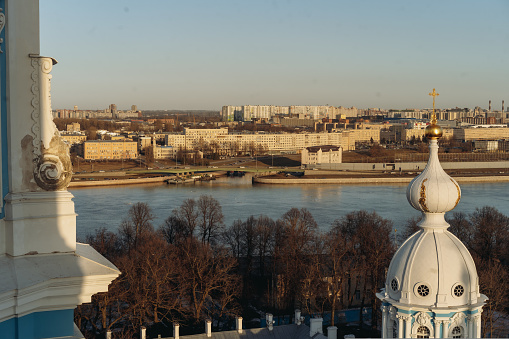 Panoramic top view of Saint petersburg and Neva river from bell loft observation deck of Smolny cathedral. Sunset in city