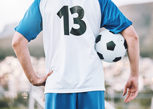 Back, soccer and man with ball, training and ready for competition, wellness and healthy lifestyle. Football, male athlete and player prepare for match, practice and fitness for cardio and endurance