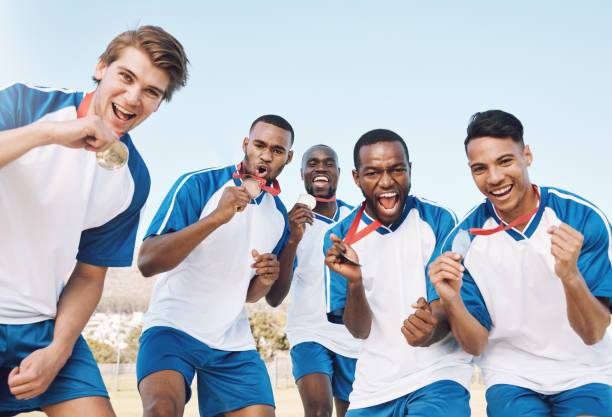 man, soccer players and celebration with gold medal for victory, championship or winning match or game. portrait of happy sporty team celebrating trophy for sports tournament or competition on field - soccer celebration success group of people imagens e fotografias de stock