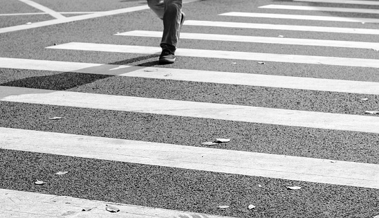 A man is walking on crosswalk