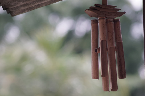 bamboo wind chimes to make music of wind with blurred background