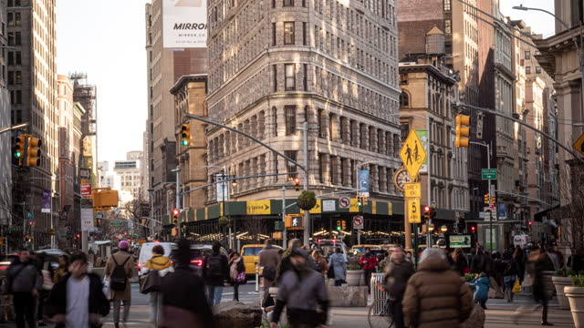 Time lapse of Flatiron Building with pedestrians and traffic road, New York City, United States