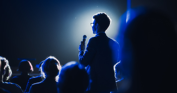 Businessman speaking at a podium in a conference or seminar