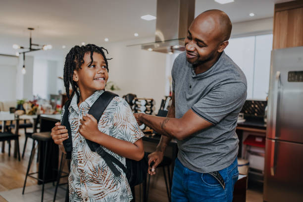 istock Father helping son with his backpack to go to school 1482845834