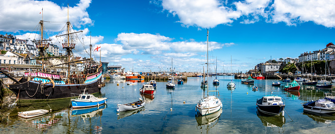 Panorama showing Brixham Harbour with boats moored