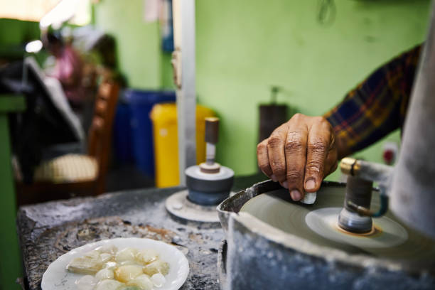 Hand of jeweler is processing Moonstone for jewel Hand of jeweler is processing Moonstone, which is mined from mine in Sri Lanka. Jewelry is made from this unique gemstones. feldspar stock pictures, royalty-free photos & images