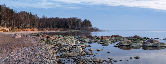 Landscape with sandstone cliffs, stony seaside of Vidzeme, Latvia. Photographed on a spring evening.