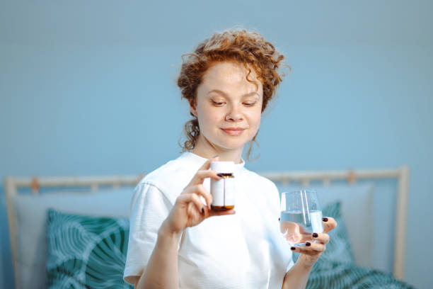 istock Woman taking medicines at home 1482851309