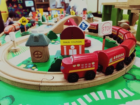 Wooden toys for children, red wooden trains, train tracks and stations to enhance imagination.