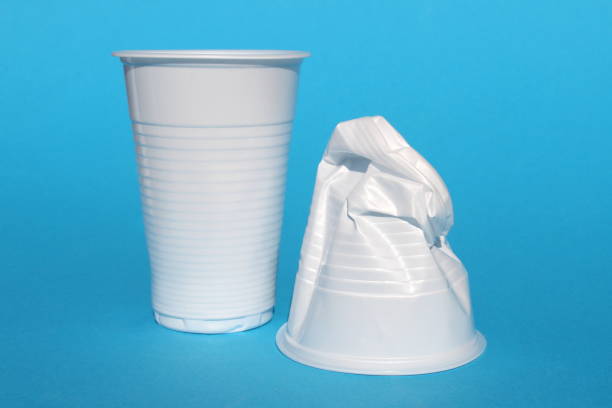istock Whole and crushed disposable glasses stand on a blue background. 1482855805