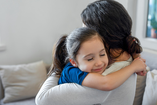 Daughter embracing her mother