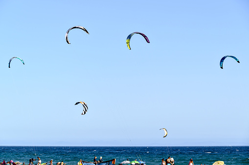 Los Caños de Meca, Barbate, Cádiz; August 19, 2022: athletes practicing kitesurfing in front of the beach of the Trafalgar Lighthouse