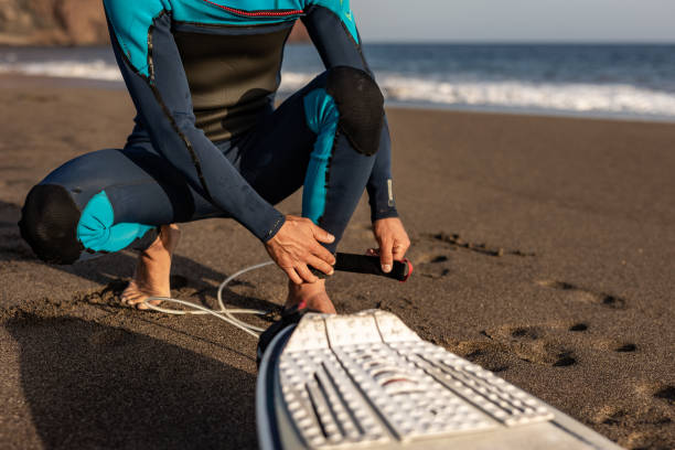 Smiling young man with surfboard on the beach.