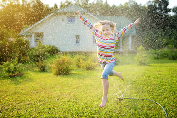 Free Stock Photo of Kids playing in water sprinklers on lawn | Download ...