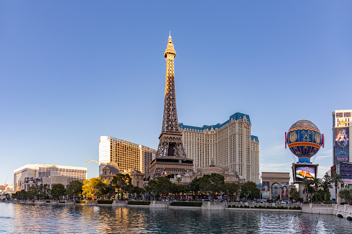Las Vegas, United States - November 23, 2022: A picture of the Eiffel Tower and Balloon Sign of Paris Las Vegas, with the main building in the back and the Bellagio Fountain in the foreground.