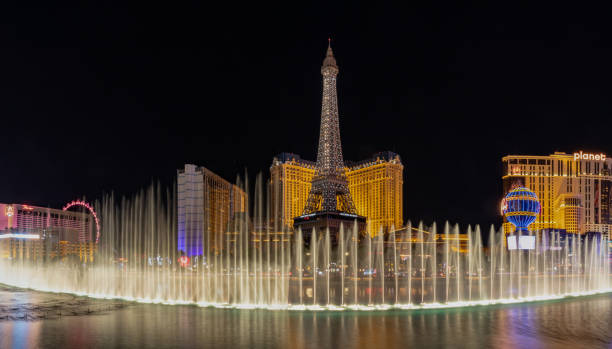 Las Vegas, Nevada - April 14, 2024: Bellagio Fountains Perform their Dance in front of the Eiffel Tower Replica