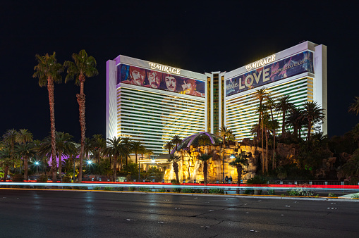 Las Vegas, United States - November 23, 2022: A picture of the Mirage at night, with a large ad of the show Love by Cirque du Soleil, about the Beatles, on its facade.