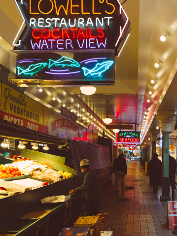 Seattle, United States of America - February 1, 2023: Pike Public Market in Seattle, Washington State, is a food lover's paradise with an abundance of fresh and flavorful offerings from the Pacific Northwest. From succulent seafood and artisanal cheese to juicy fruit and locally roasted coffee, the market is a culinary delight. Visitors can savor the taste of the region with a bowl of clam chowder, a freshly shucked oyster, or a steaming cup of chowder. They can also indulge in artisanal chocolates, pastries, and handmade ice cream. With an emphasis on locally sourced and sustainably produced food, Pike Public Market is a must-visit destination for anyone seeking to experience the unique flavors of the Pacific Northwest.