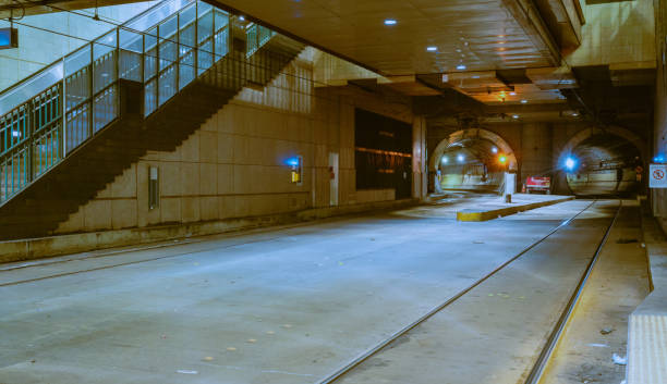 view down a train track tunnel path exchange place station new york new jersey (ny nj transit commuter) turn curve dark