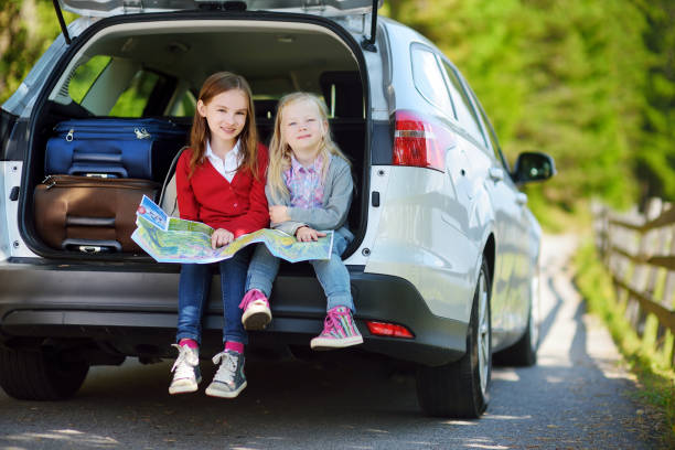 istock Two adorable little sisters exploring a map before going on vacations with their parents 1482860419