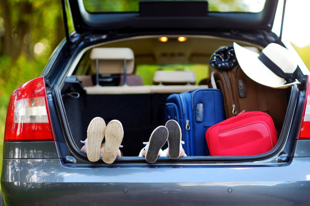 istock Two adorable little sisters sitting in a car 1482860603