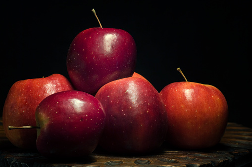 Very sweet and ecological red apples on a black background collected on the Iberian Peninsula.