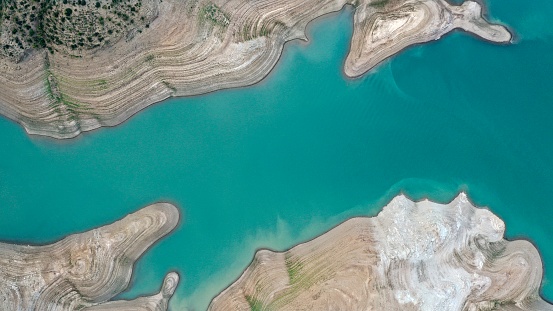 Aerial landscape of turquoise river in desert by drone