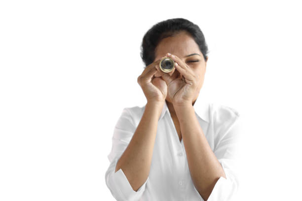 Female Using Vintage Monocular Young woman in formal wear looking through a vintage monocular. monocular vision stock pictures, royalty-free photos & images