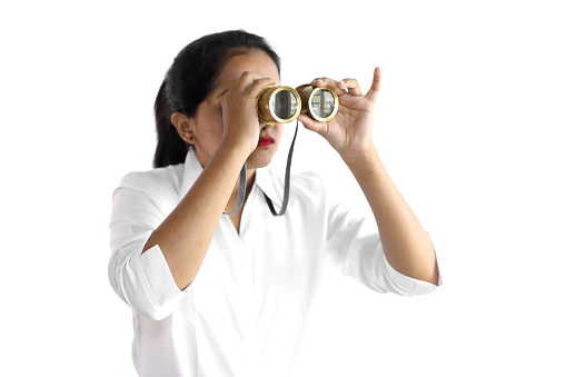 Young woman in a formal wear using an old-fashioned binocular.
